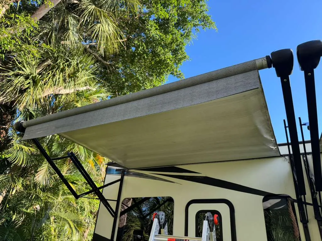Coast to Coast RV technician replacing an RV awning at a Florida campground