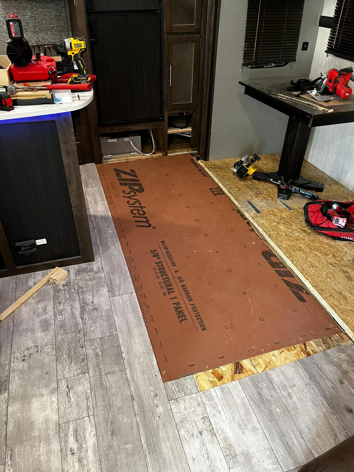 Coast to Coast RV technician fixing the floor after a water leak inside an RV